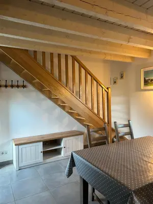 a staircase in a room with a table and chairs at Aux portes du Sidobre in Noailhac