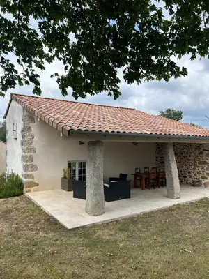 a small stone house with a red roof at Aux portes du Sidobre in Noailhac