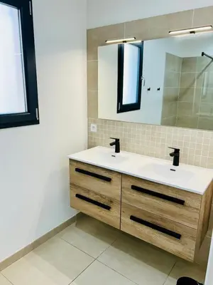 a bathroom with a sink and a mirror at Villa de vacances avec piscine in Nissan-lez-Enserune