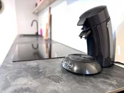 a coffee maker sitting on a counter in a kitchen at T3 l 65m 2 l Bright & Quiet in Castres