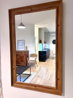 a mirror on the wall of a living room at T3 l 65m 2 l Bright & Quiet in Castres