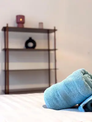 a blue stuffed animal laying on a bed with a table at T3 l 65m 2 l Bright & Quiet in Castres