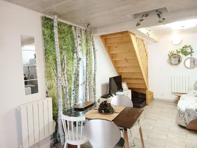 a small living room with a table and chairs at L'Écrin des Bois - Au bord de l Aude in Espéraza