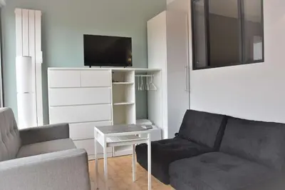 a living room with a couch and a tv at Appartement Rénové avec Balcon sur le Port GN460-010 in Gruissan