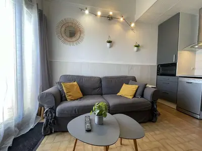 a living room with a couch and a table at Appartement climatisé résidence Grande Voile GN160-434 in Gruissan