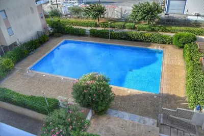 an overhead view of a large blue swimming pool at Appartement climatisé résidence Grande Voile GN160-434 in Gruissan