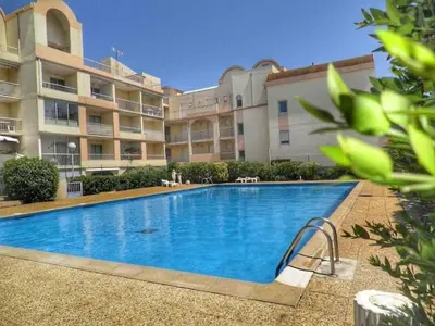 a large swimming pool in front of a building at Appartement climatisé résidence Grande Voile GN160-434 in Gruissan