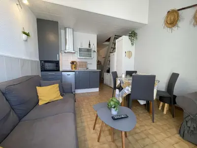 a living room with a couch and a table at Appartement climatisé résidence Grande Voile GN160-434 in Gruissan