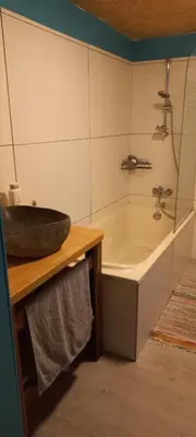a bathroom with a sink and a bath tub at Maison calme in Payrin-Augmontel