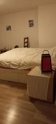 a bedroom with a bed with a table next to it at Maison calme in Payrin-Augmontel