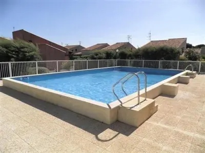 a large swimming pool in a yard at Pavillon climatisé - proche plage du grazel Gruissan GN510-019 in Gruissan