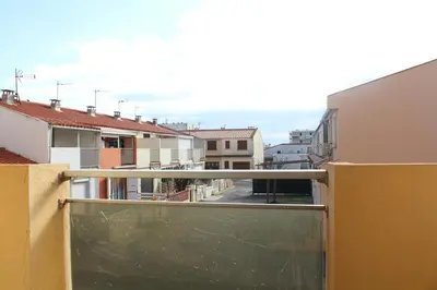 a balcony with a view of a street and buildings at Appartement 2 pièces PORT LA NOUVELLE PN440-007 in Port-la-Nouvelle