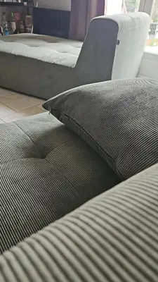 a bed with a pillow and a chair in a room at Maison Lauraguais cosy jardin brasero, vue étoilée in Saint-Paulet