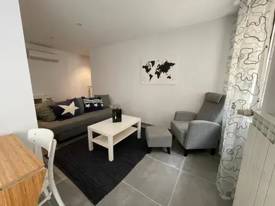 a living room with a couch and a table at Modern apartment centrally located in Quarante in Quarante