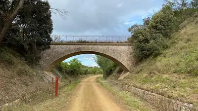 a bridge over a dirt road with a dirt road at Modern apartment centrally located in Quarante in Quarante