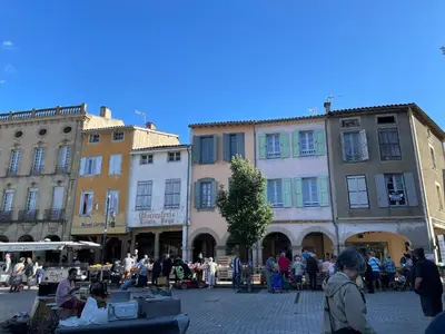 a group of people standing around in a street with buildings at Chez Cathie & Didier in Revel