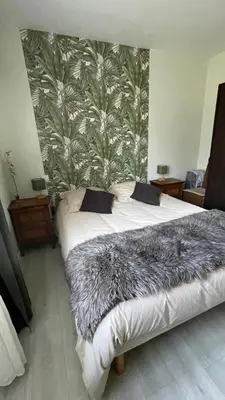 a bedroom with a large bed with a furry blanket at Chez Cathie & Didier in Revel