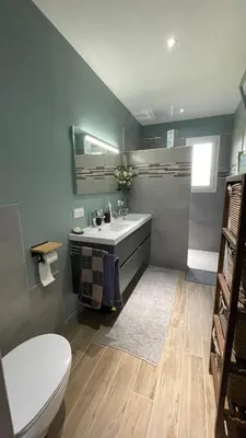 a bathroom with a white toilet and a sink at Chez Cathie & Didier in Revel