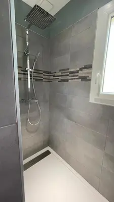 a bathroom with a shower with a shower head at Chez Cathie & Didier in Revel