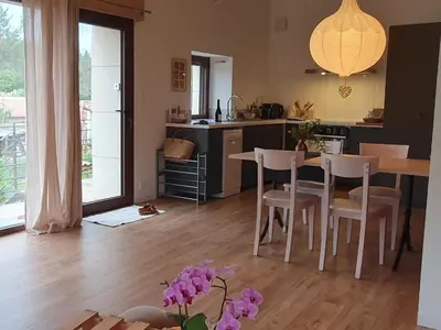 a kitchen and dining room with a table and chairs at Château les Poules in Assignan