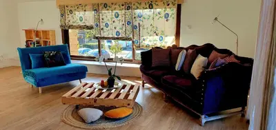 a living room with a couch and a table at Château les Poules in Assignan
