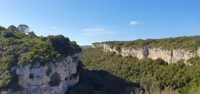 a view of a canyon with trees and cliffs at Château les Poules in Assignan