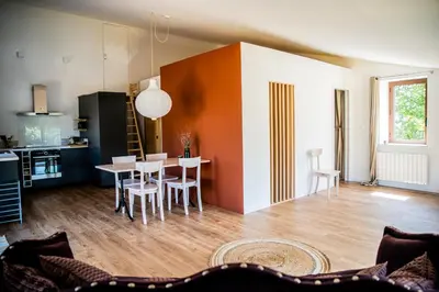a kitchen and dining room with a table and chairs at Château les Poules in Assignan