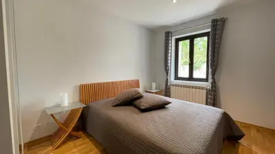 a bedroom with a bed and a window at Modern apartment large terrace and beautiful view in Quarante