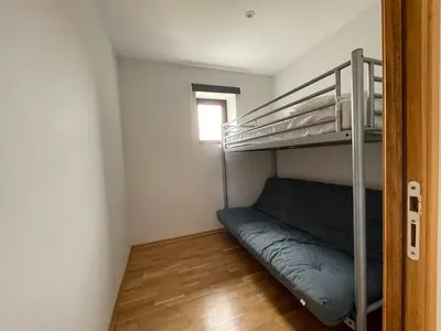 a small room with a bunk bed and a window at Modern apartment large terrace and beautiful view in Quarante