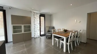 a kitchen and dining room with a table and chairs at Modern apartment large terrace and beautiful view in Quarante
