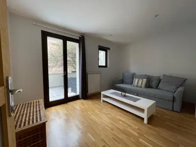 a living room with a couch and a coffee table at Modern apartment large terrace and beautiful view in Quarante