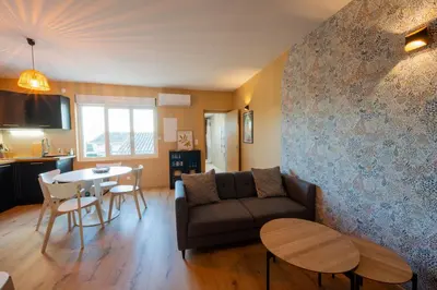 a living room with a couch and a table at La Pause Carcassonnaise in Carcassonne