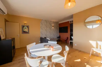 a living room with a white table and chairs at La Pause Carcassonnaise in Carcassonne