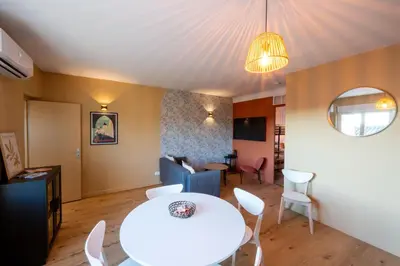 a living room with a white table and chairs at La Pause Carcassonnaise in Carcassonne