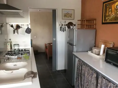 a kitchen with a sink and a refrigerator at Domaine Castelsec in Roquefort-des-Corbières