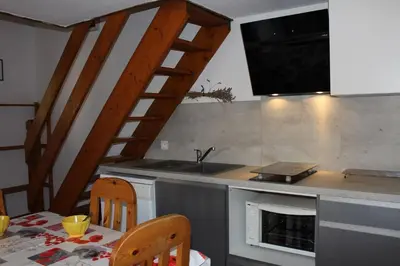 a kitchen with a sink and a counter with a table at Pavillon Cosy 3 pièces avec véranda et parking GN520-048 in Gruissan
