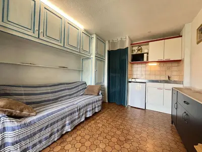 a small kitchen with a bed in a room at Appartement Studio Cabine - Gruissan GN020-211 in Gruissan