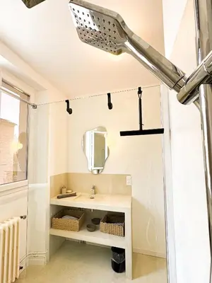 a bathroom with a sink and a mirror at Maison Agane - accès canal du midi, piscine chauffée in Pexiora
