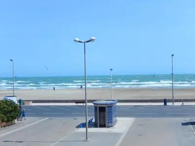 a parking lot next to a beach with a street light at Appartement 3 pièces PORT LA NOUVELLE PN540-008 in Port-la-Nouvelle