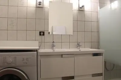 a bathroom with a sink and a washing machine at Appartement 3 pièces PORT LA NOUVELLE PN540-008 in Port-la-Nouvelle