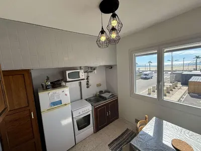 a small kitchen with a white refrigerator and a window at Appartement 3 pièces PORT LA NOUVELLE PN540-008 in Port-la-Nouvelle