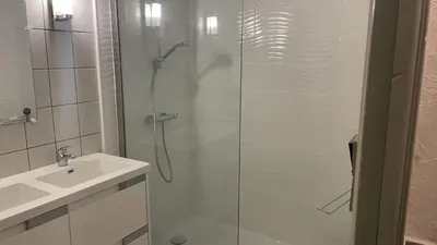 a shower with a glass door next to a sink at Appartement 3 pièces PORT LA NOUVELLE PN540-008 in Port-la-Nouvelle