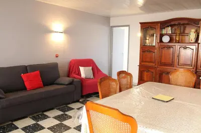 a living room with a couch and a table and chairs at Appartement 3 pièces PORT LA NOUVELLE PN540-008 in Port-la-Nouvelle