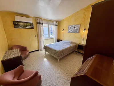 a bedroom with a bed and a window at Maison 3 pièces mezzanine PORT LA NOUVELLE PN000-107 in Port-la-Nouvelle