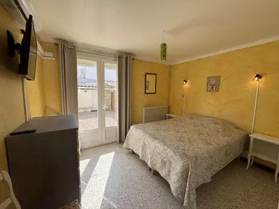 a room with two beds and a table at Maison 3 pièces mezzanine PORT LA NOUVELLE PN000-107 in Port-la-Nouvelle