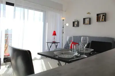 a living room with a table with wine glasses at Appartement studio PORT LA NOUVELLE PN590-014 in Port-la-Nouvelle