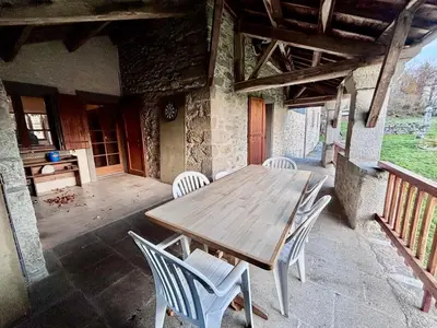 an entrance to a stone house with a stone wall at Maison au coeur de la forêt dans le Sidobre - GR36 in Lacrouzette