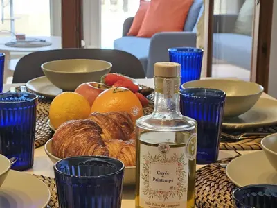 a table with a bottle of wine and a plate of fruit at Belle Bize in Bize-Minervois