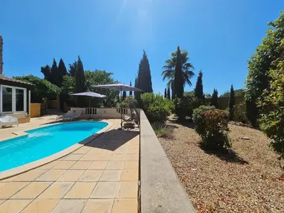 a swimming pool in a yard with a house at Belle Bize in Bize-Minervois