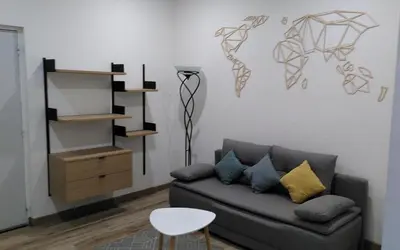a living room with a couch and a table at RDC cosy en centre ville in Narbonne